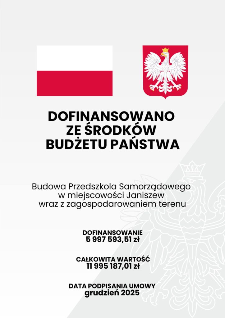 Tablica: flaga i herb Polski, Dofinansowano ze środków Budżetu Państwa, Budowa Przedszkola Samorządowego w miejscowości Janiszew wraz z zagospodarowaniem terenu, dofinansowanie 5 997 593,51 zł, całkowita wartość 11 995 187,01 zł, data p[odpisania umowy grudzień 2025
